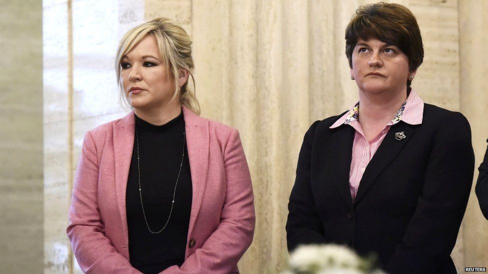 Sinn Fein leader Michelle O'Neill stands alongside DUP leader Arlene Foster