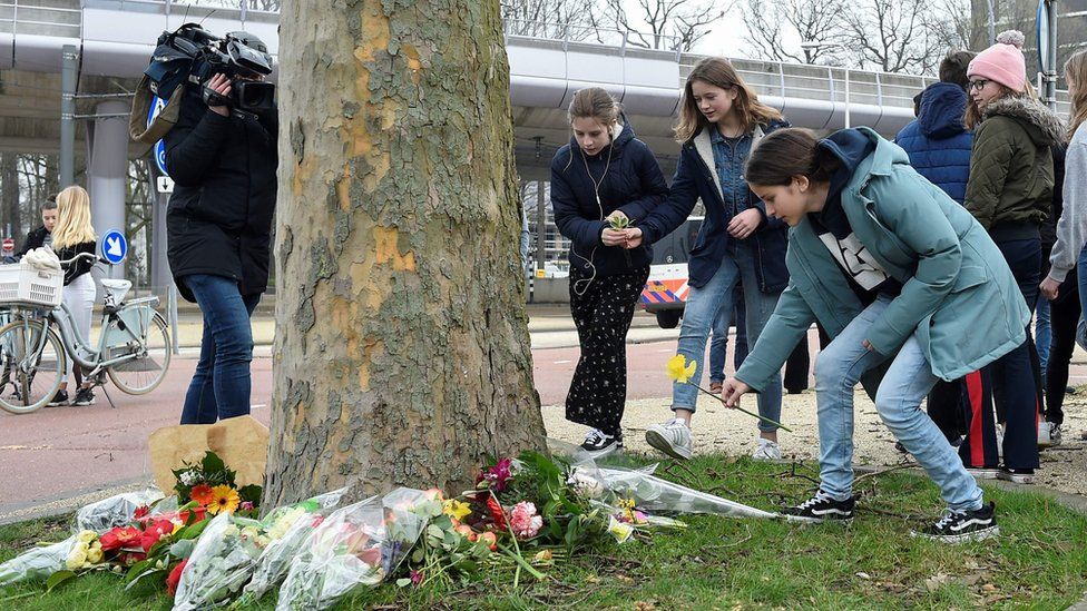 Teenagers were among many laying flowers at the scene of Monday's shooting in Utrecht on Tuesday