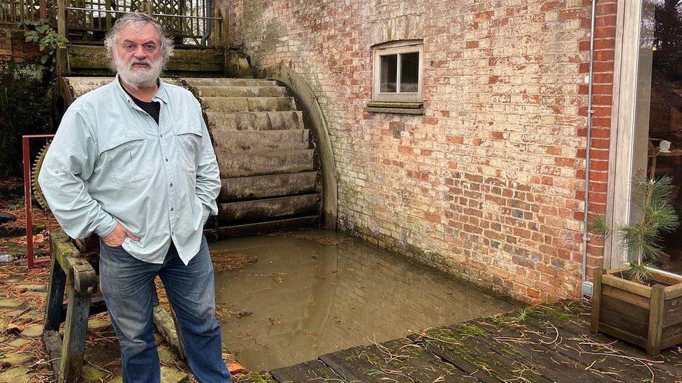 Man by water wheel