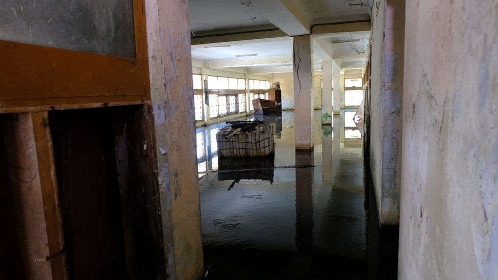 Picture of a flooded ground floor of the abandoned building.