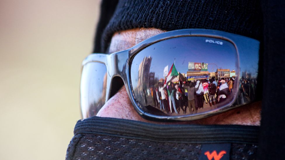 Anti-coup demonstrators reflected in the glasses of a protester in Khartoum, Sudan - Thursday 20 January 2022