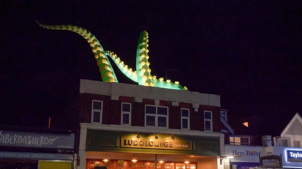 Illuminated tentacles on top of a pub in Southbourne