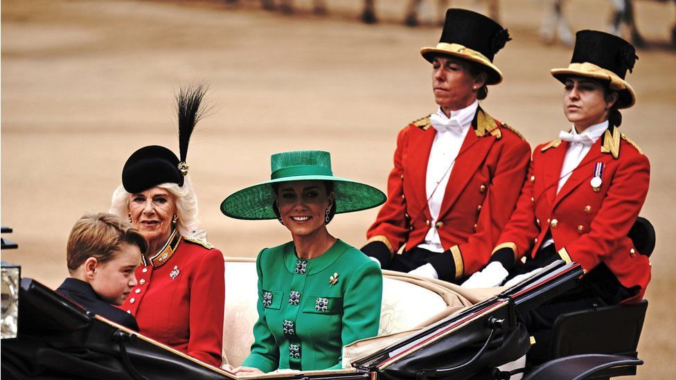 Queen Camilla, the Princess of Wales ride along in a carriage