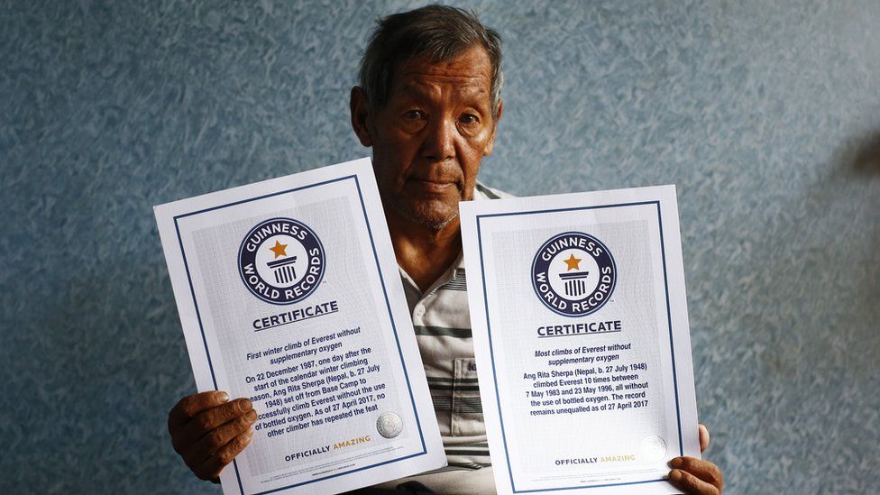 Ang Rita Sherpa holds his Guinness World Records certificates