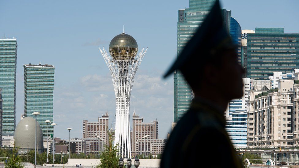 A soldier stands guard with a view of the Kazakh capital Astana in the background.