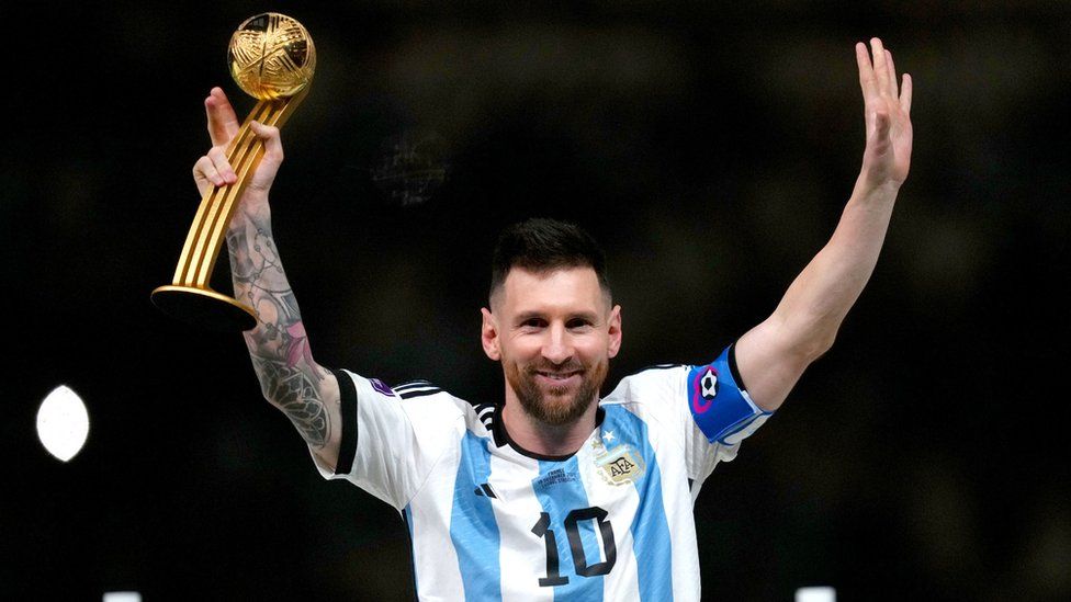 Lionel Messi holds up the Golden Ball trophy