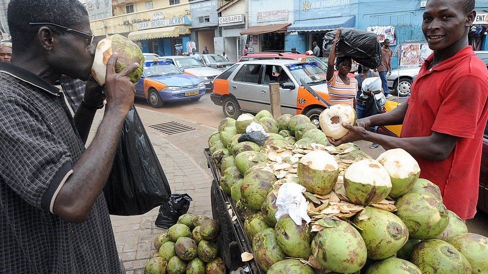 Man drinking coconut water