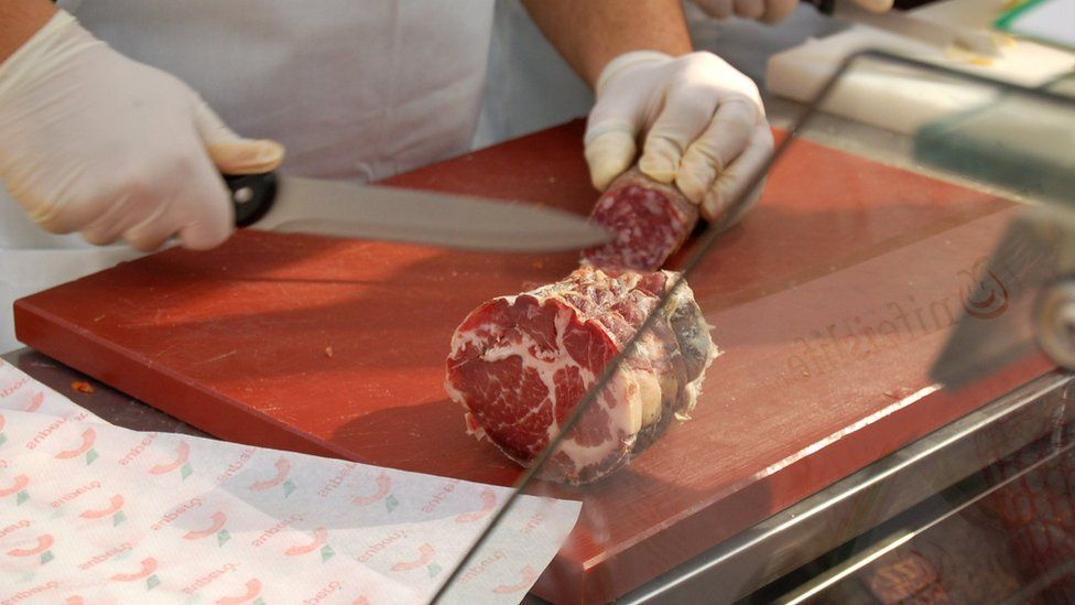 Parma ham being sliced