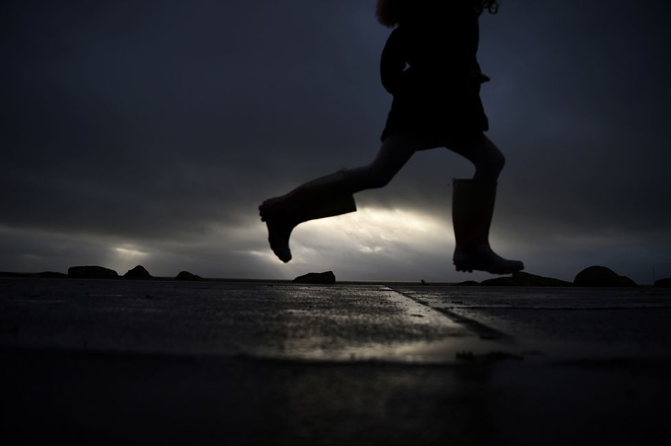 A girl runs in her Wellington boots as storm Barra makes landfall in Galway, Ireland, 7 December 2021.