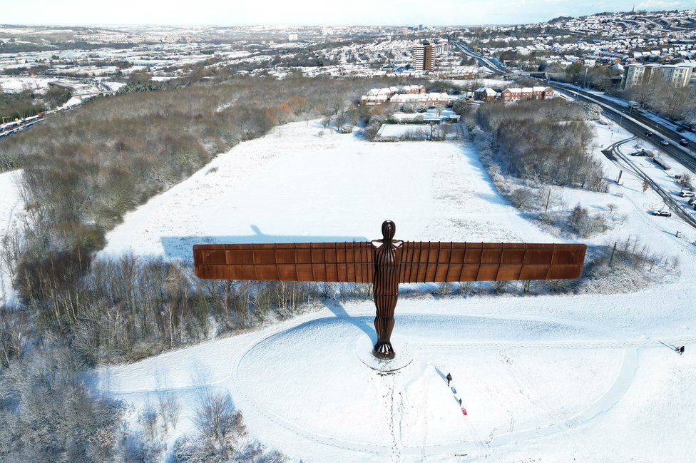 Aerial view of snow surrounding the Angel of the North
