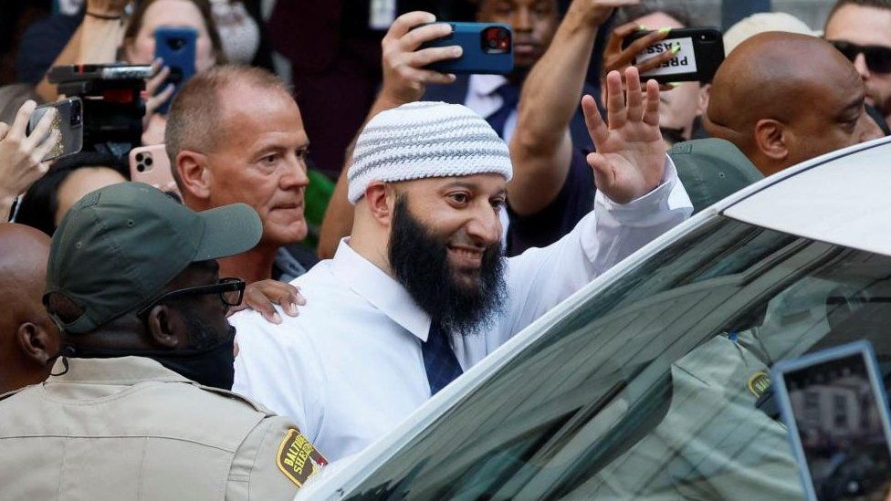 Adnan Syed waving to supporters after his release from prison.