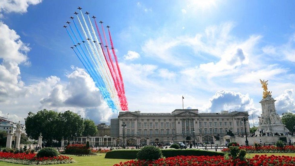 Red Arrows and La Patrouille fly over Buckingham Palace