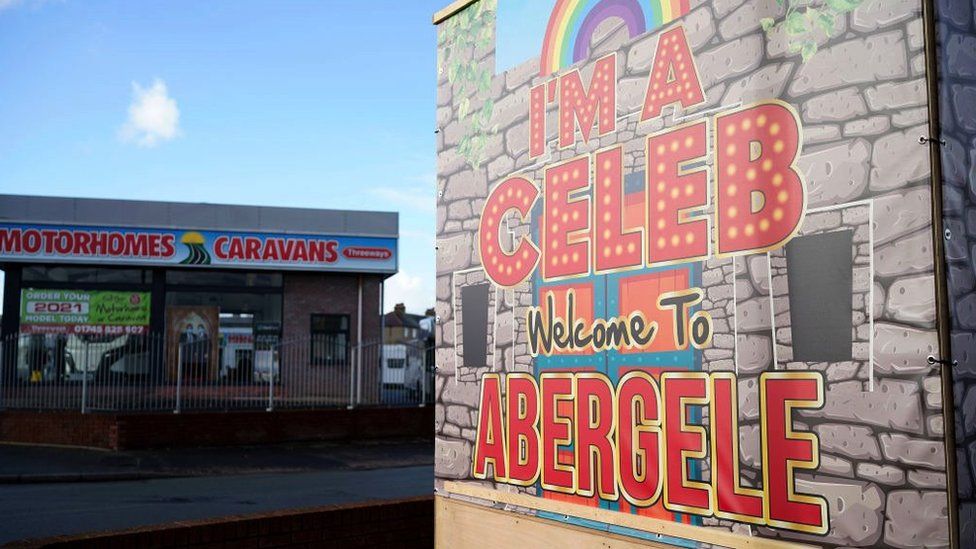 A sign at a caravan showroom reading 'I'm a Celeb welcome to Abergele.'