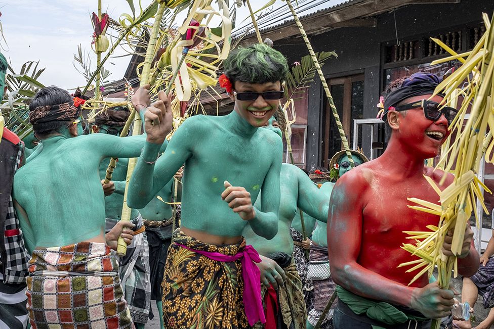 People with painted bodies march during the sacred Ngerebeg ritual at Tegallalang village in Gianyar, Bali, Indonesia. 8 February 2023.
