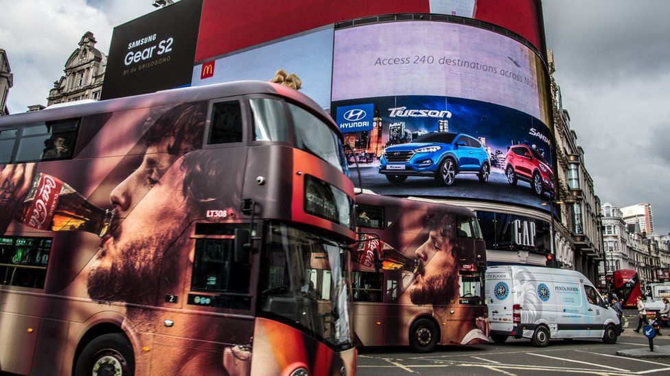 Buses covered in advertising at London's Piccadilly Circus