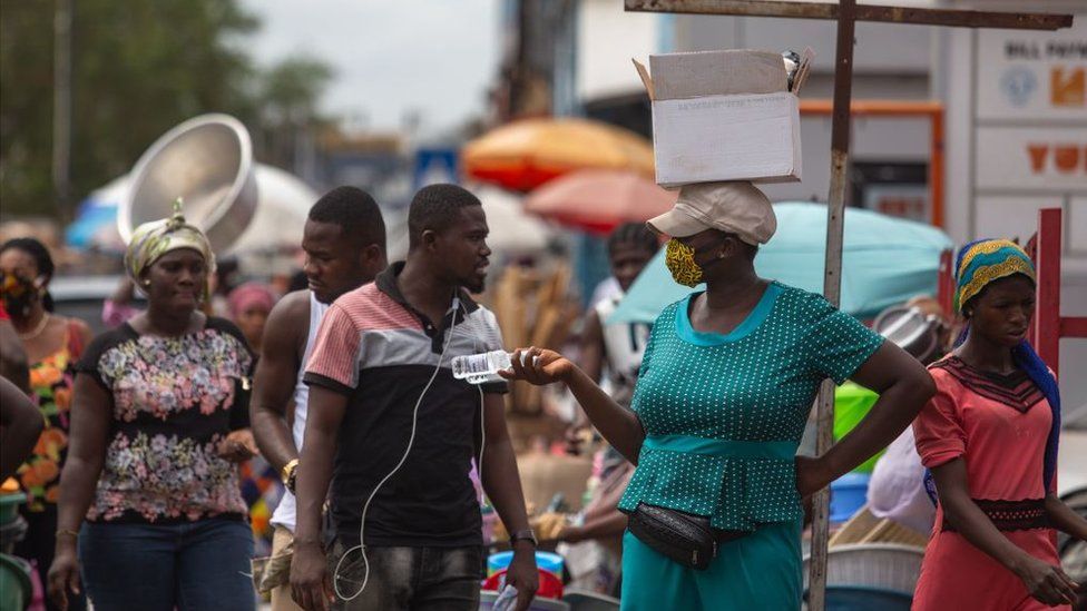 A woman sells hand sanitizer in Accra, Ghana, April 2020