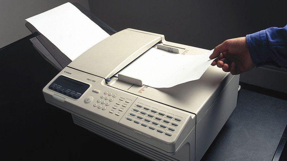 A fax machine in use