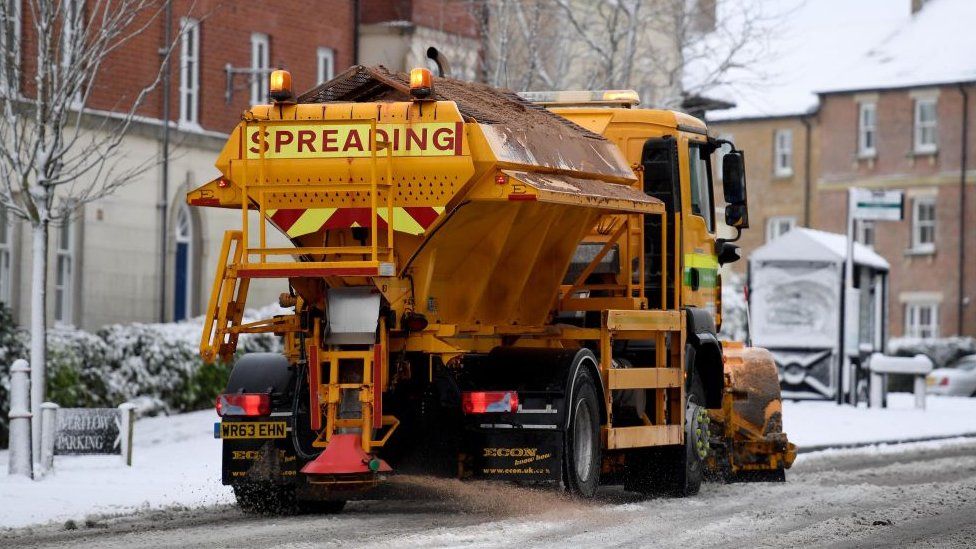 gritter on road with snow