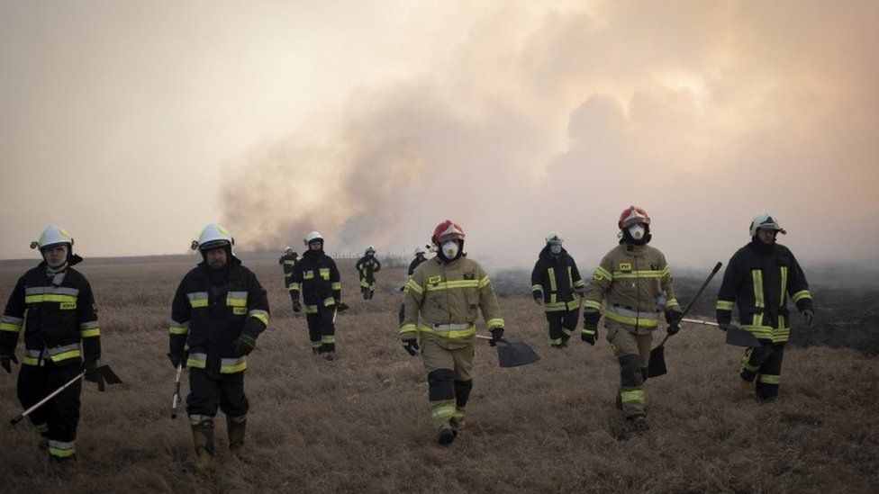 Firefighter attacks flames in Poland