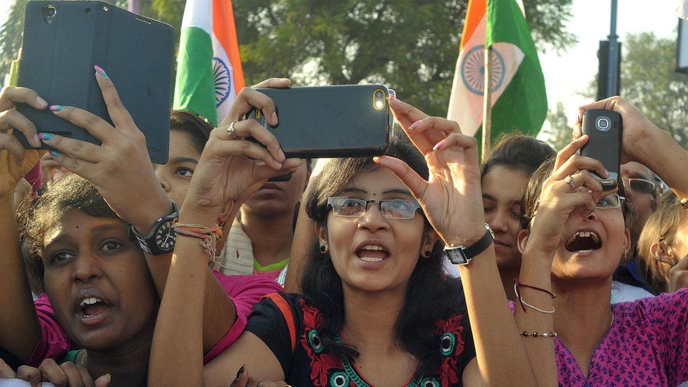 Indian students use cellphones to photograph