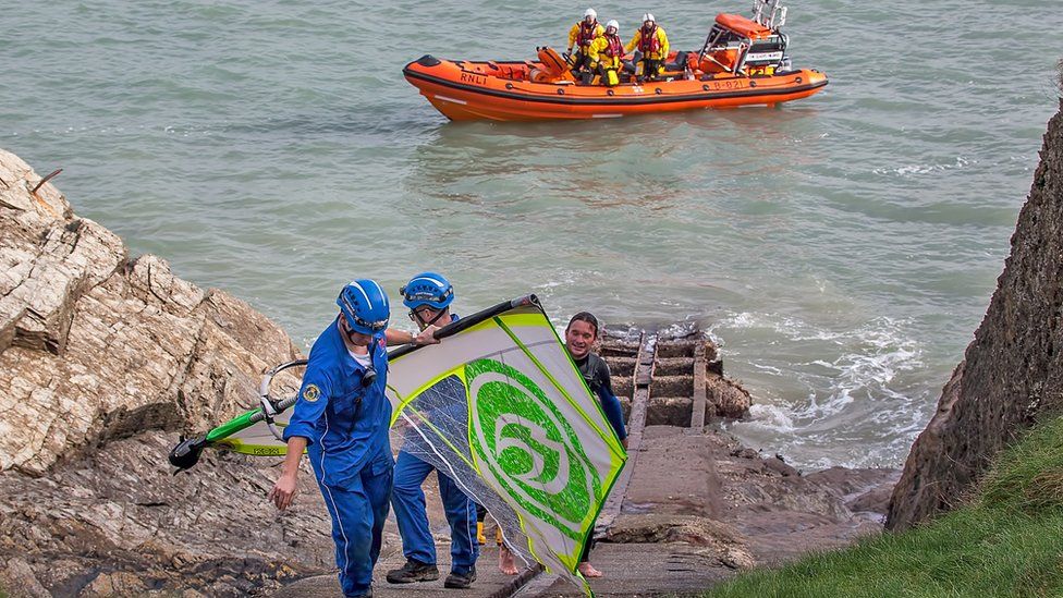 Windsurfer being rescued.