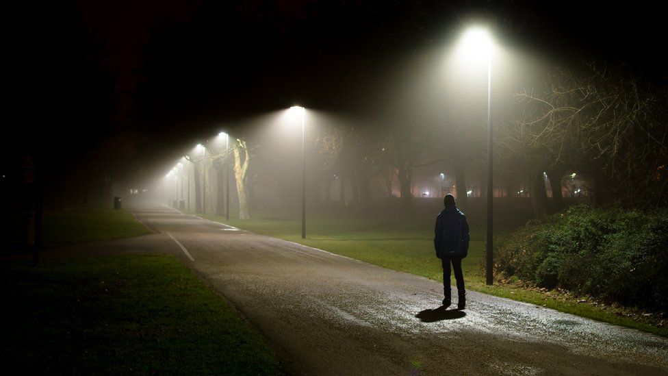 Man walking on dark night