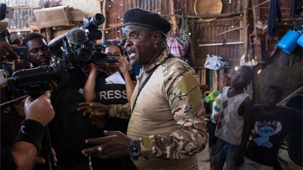 The leader of Haiti's main armed gang, Jimmy Cherizier, alias Barbecue, speaks to the media during a tour of the La Saline neighbourhood, in Port-au-Prince, Haiti, 03 November 2021.