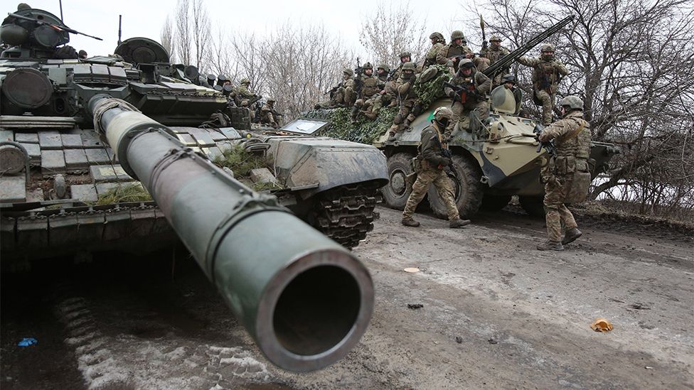 Ukrainian servicemen stand on a tank as they get ready to repel an attack in Ukraine's Lugansk region.