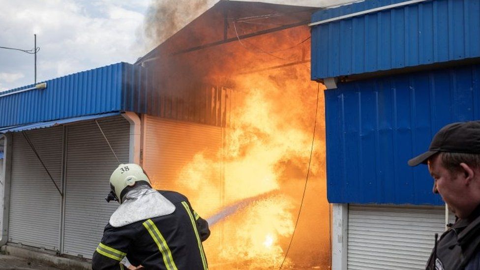 Firefighters tackle a blaze at a market in Slovyansk, eastern Ukraine, after Russian shelling. Photo: 5 July 2022
