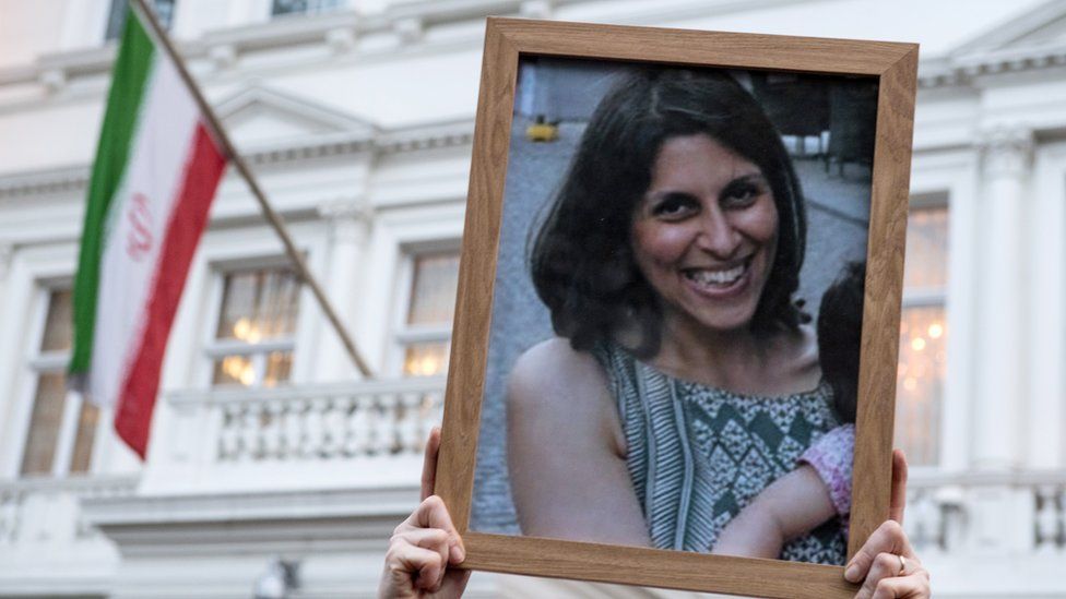 Supporters hold a photo of Nazanin Zaghari-Ratcliffe during a vigil outside the Iranian Embassy in London