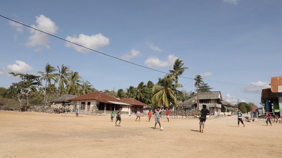Boys playing football in Abdul's town