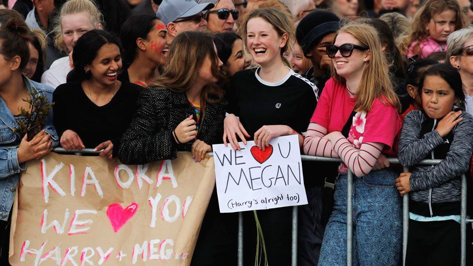 Signs held up for the arrival of the Duke and Duchess of Sussex