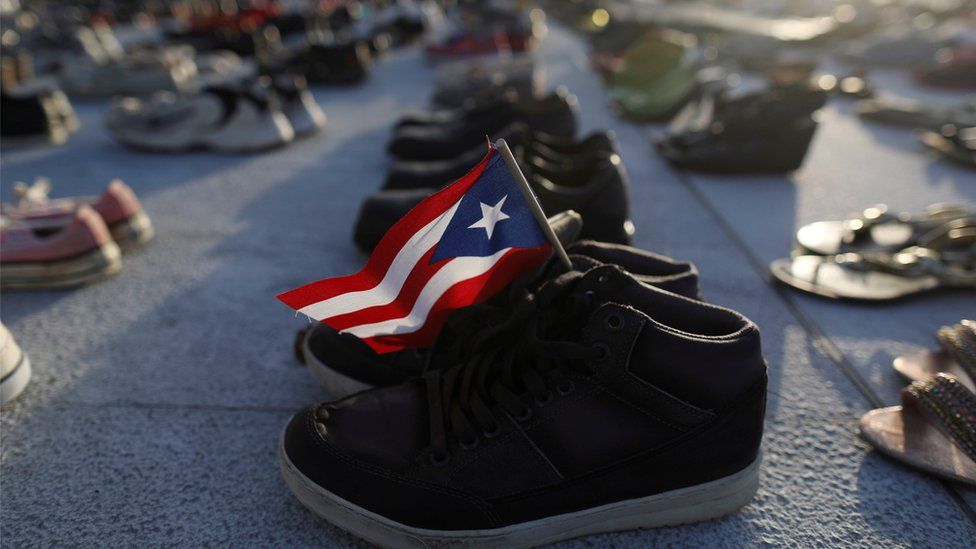 A Puerto Rican flag is seen on a pair of shoes as hundreds of pairs of shoes displayed at the Capitol