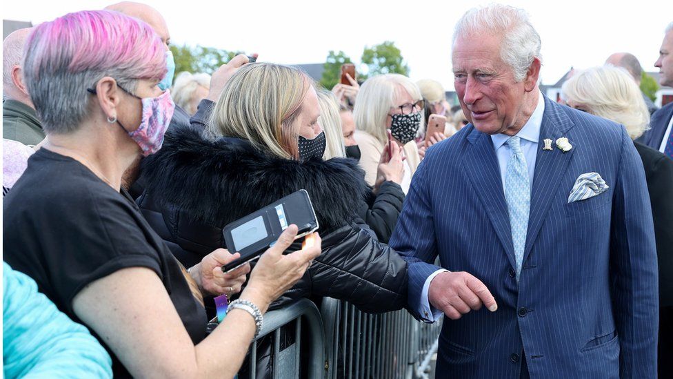 Prince Charles bumps elbows with a well-wisher at Bangor