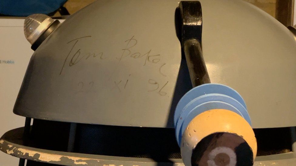 The top of the grey replica dalek, with Tom Baker's signature