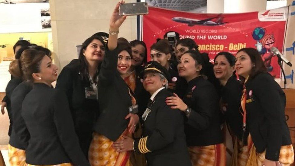The all-women crew takes pictures at San Francisco Airport