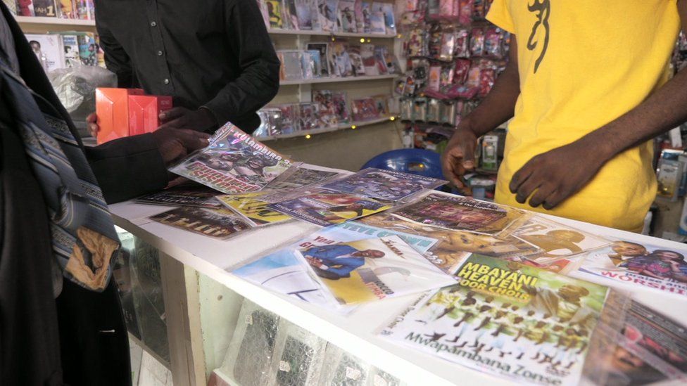 People at a pirated CD and DVD shop in Malawi