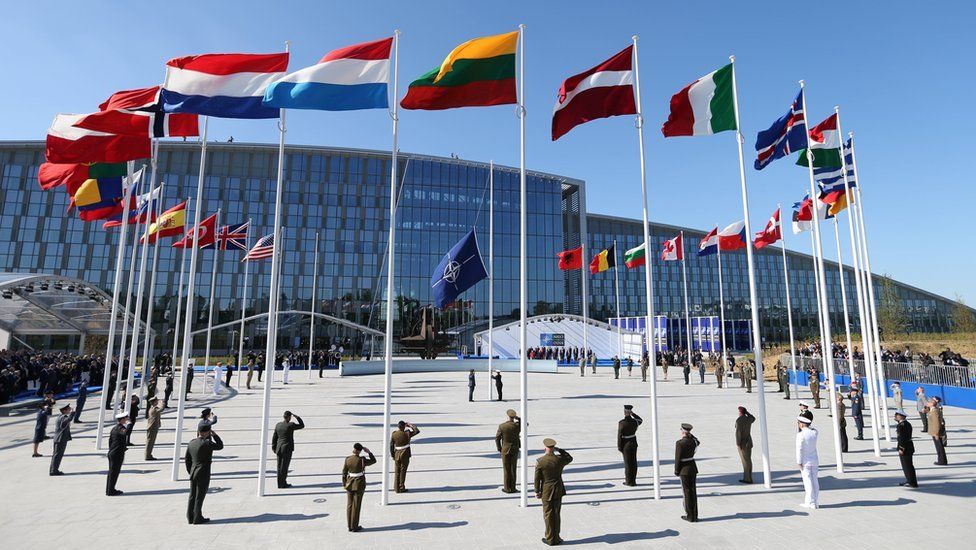 Flags of Nato member countries fly during a ceremony at the new headquarters in Brussels, 25 May