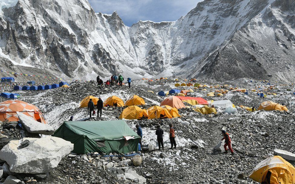 Trekkers and porters gather at Everest Base Camp on 25 April 2018.