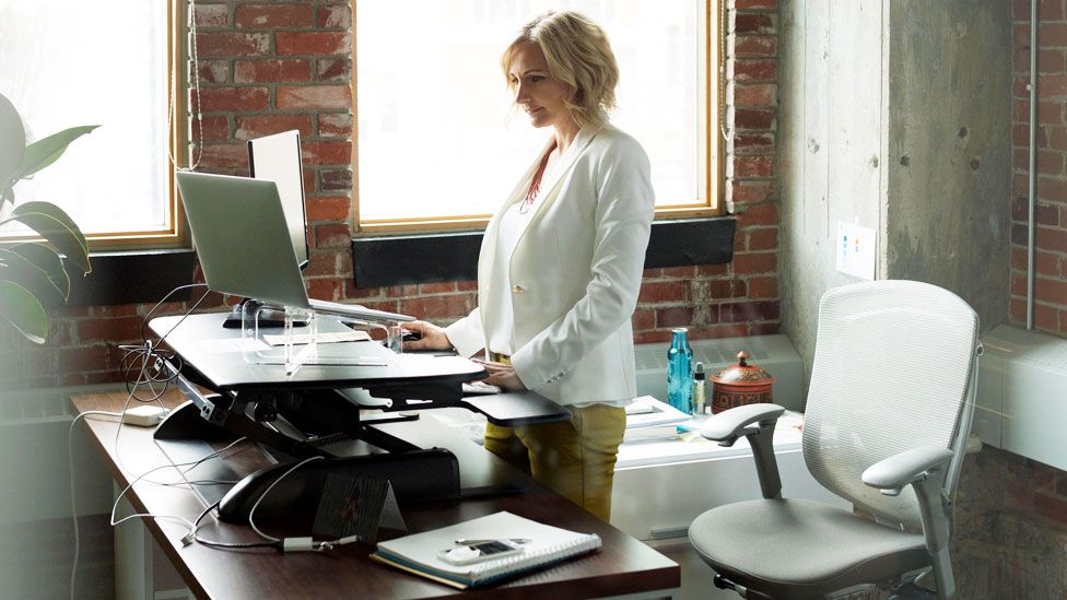 Woman standing at desk