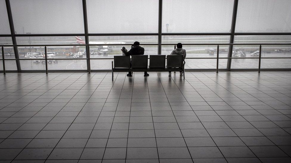 Travellers at a near empty airport