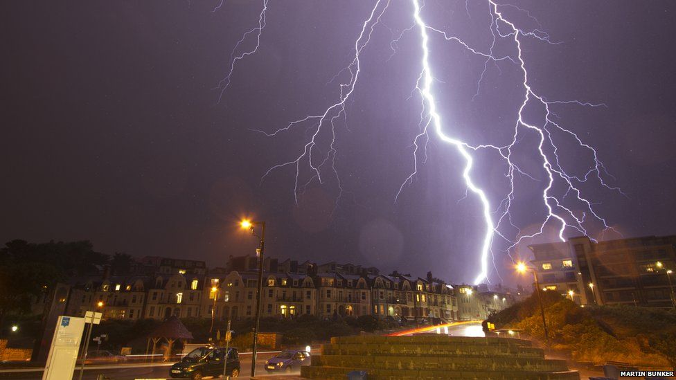 Lightning flashes over a city street