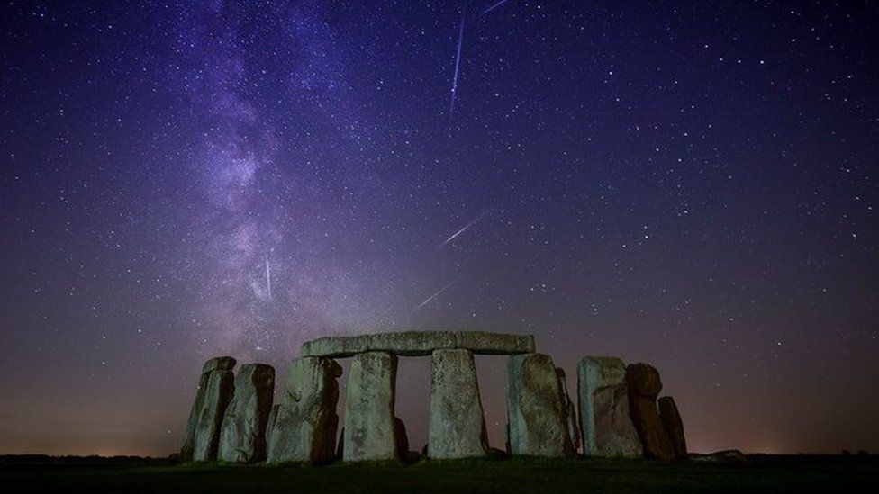 Stonehenge under a purple night sky