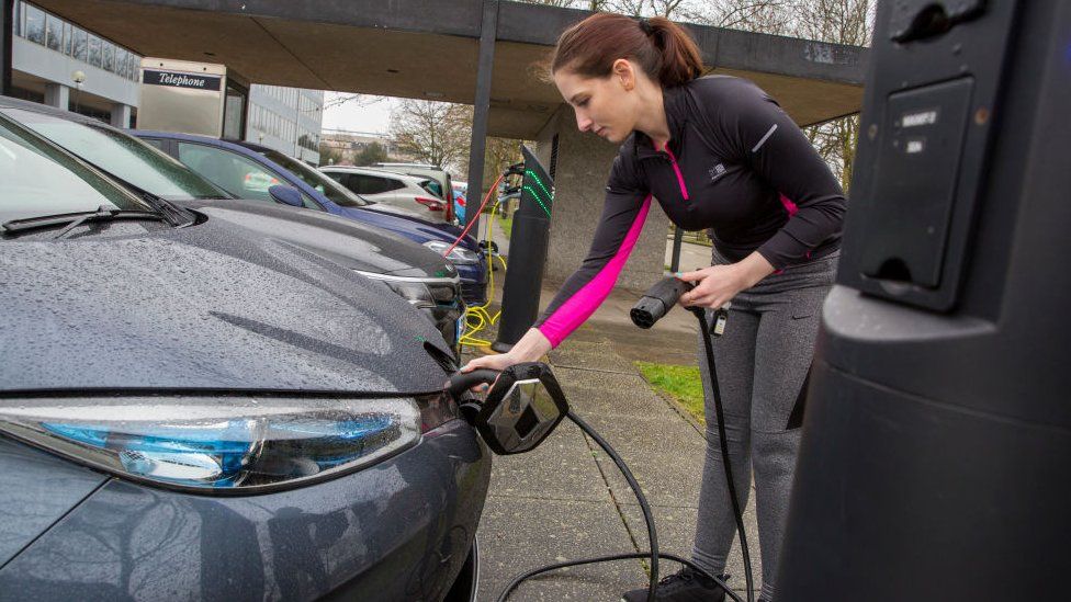 Woman charging car