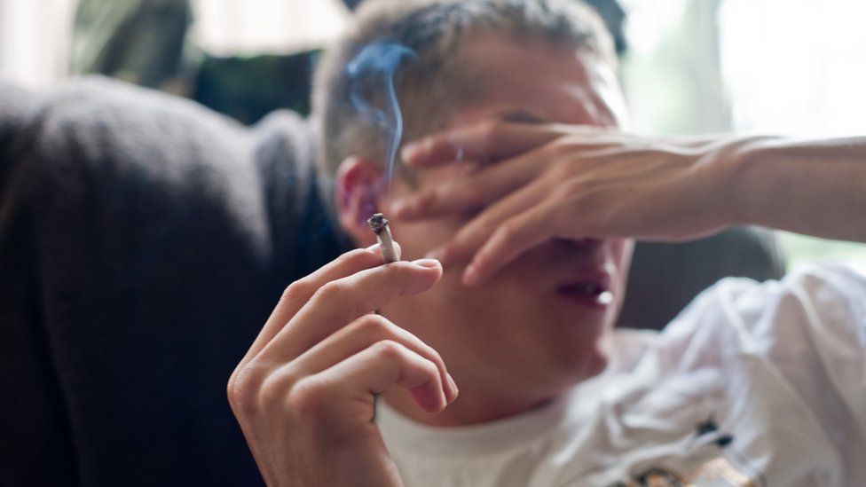 Young man smokes cannabis