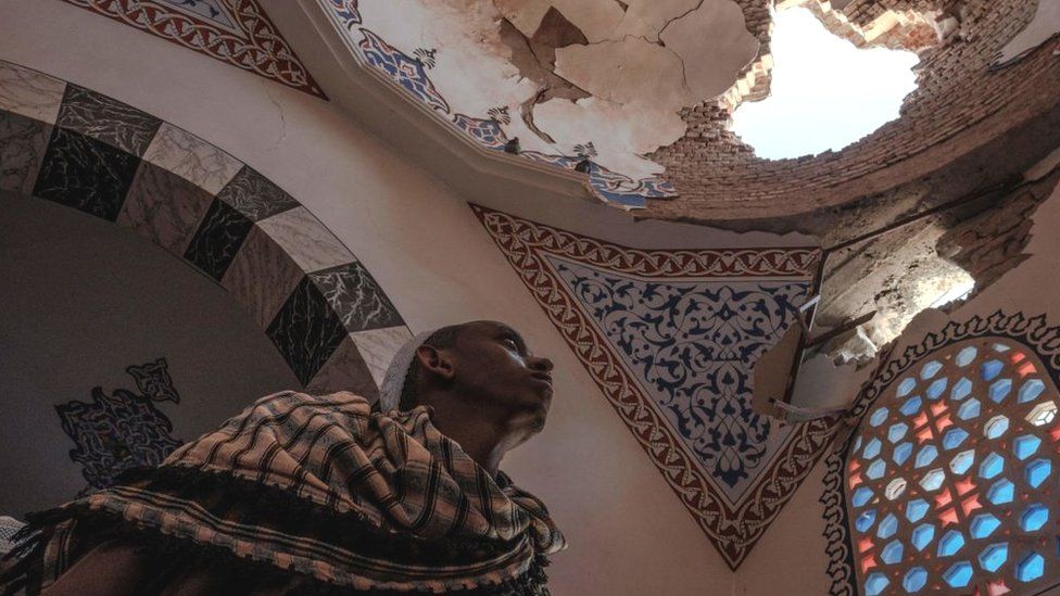 An Ethiopian Muslim stands inside a damaged mausoleum at the al-Negashi Mosque, one of the oldest in Africa and allegedly damaged by shelling, in Negash - March 2021
