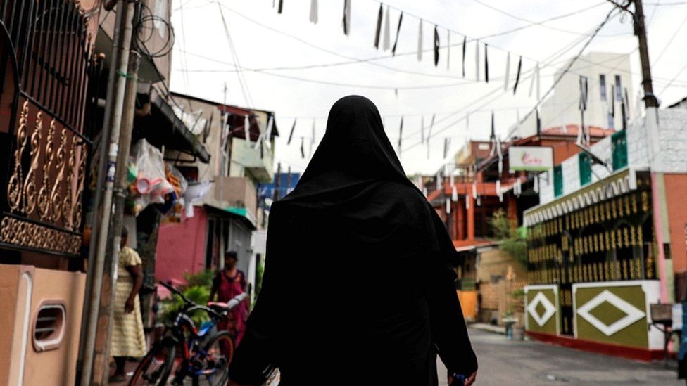 2019 File photo of a Muslim woman wearing a hijab walking through a street near St Anthony's Shrine in Colombo