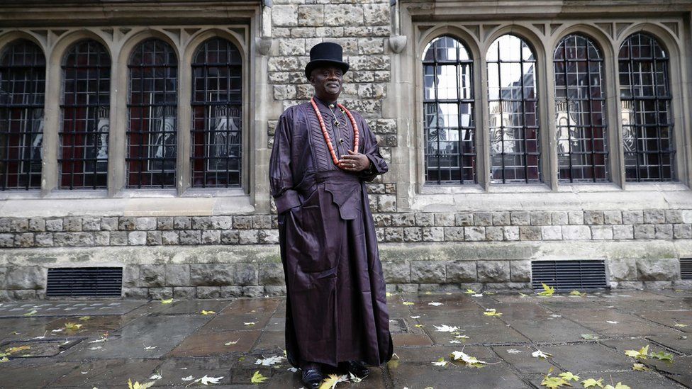 Man in traditional robes and top hat stands outside High Court in London, UK - Monday 21 November 2016