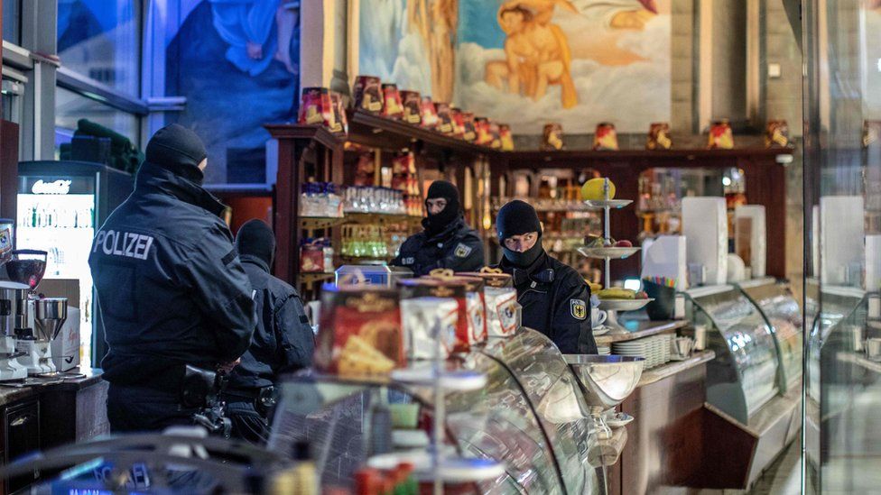 Policemen raid an ice cafe in Duisburg, western Germany, on December 5, 2018.