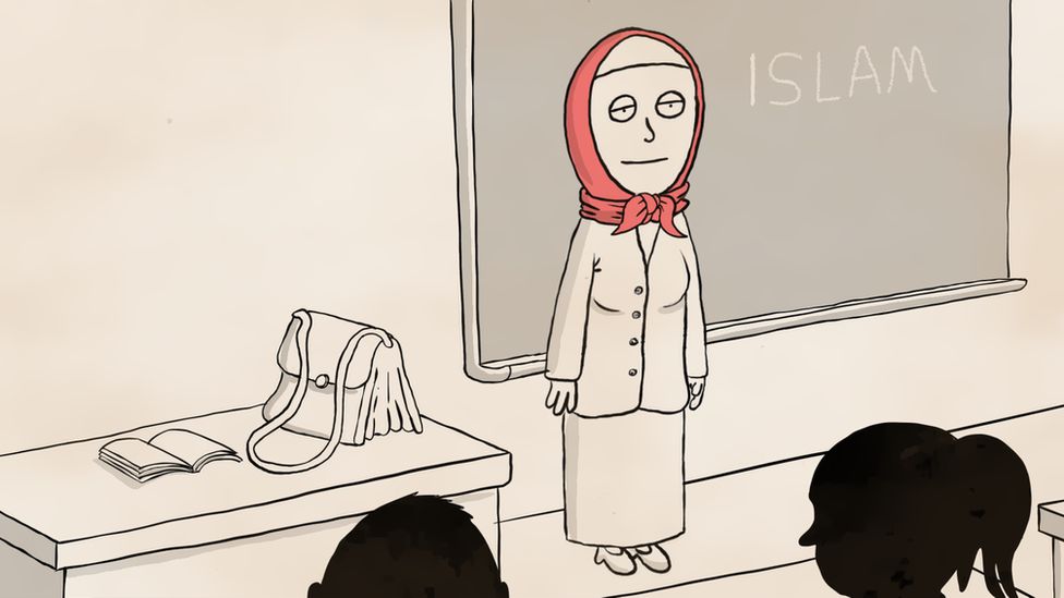 A teacher in class wearing a headscarf